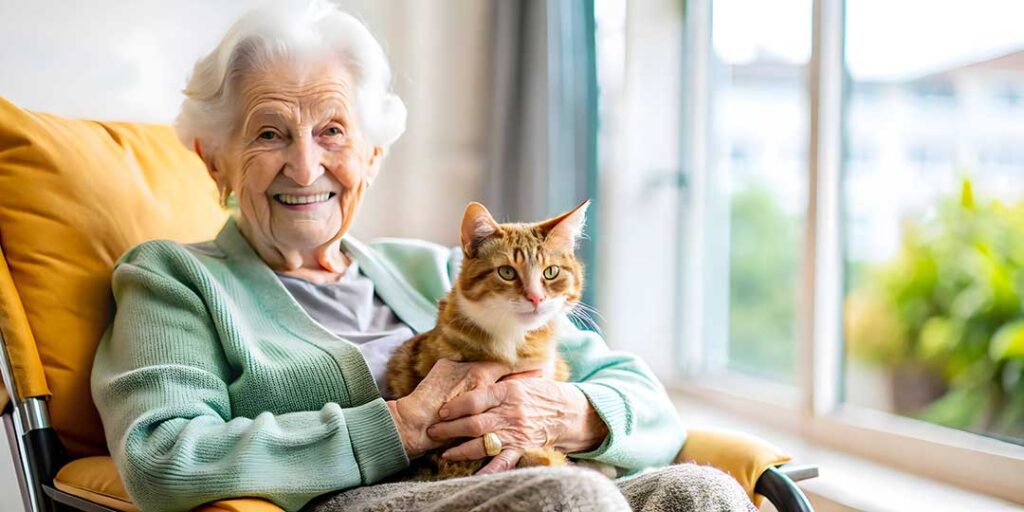 Resident choosing clothing with a caregiver in a bright, private assisted living room.